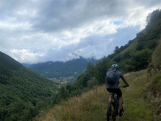 A rural officer riding a bike on a mountain overlooking the Val d'Aran valley (courtesy of the Conselh Generau d'Aran)